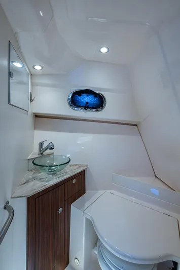 Cay Day Yacht Photos Pics 2017 Pursuit 325 OS boat bathroom with modern fixtures and porthole window.