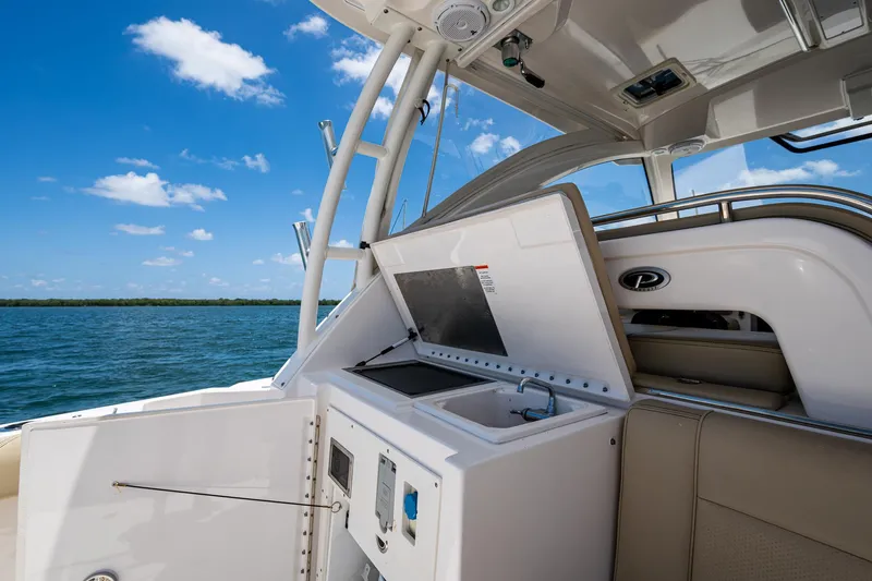 Cay Day Yacht Photos Pics 2017 Pursuit 325 OS boat interior with open storage, ocean view, and clear blue sky.