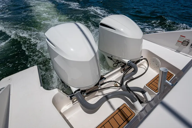Cay Day Yacht Photos Pics Twin outboard engines on a 2017 Pursuit 325 OS boat, cruising on water.