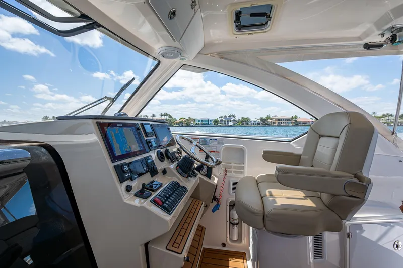 Cay Day Yacht Photos Pics 2017 Pursuit 325 OS boat cockpit with modern controls and comfortable seating.