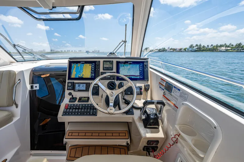 Cay Day Yacht Photos Pics 2017 Pursuit 325 OS boat cockpit with navigation equipment and ocean view.