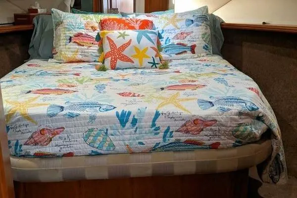  Yacht Photos Pics Cozy bed with colorful marine-themed bedding in a 2001 Silverton 42 Convertible yacht.