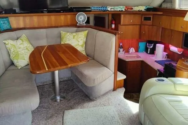  Yacht Photos Pics Interior of a 2001 Silverton 42 Convertible yacht with cozy seating and kitchenette.