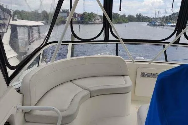  Yacht Photos Pics 2001 Silverton 42 Convertible boat interior with curved seating and waterfront view.