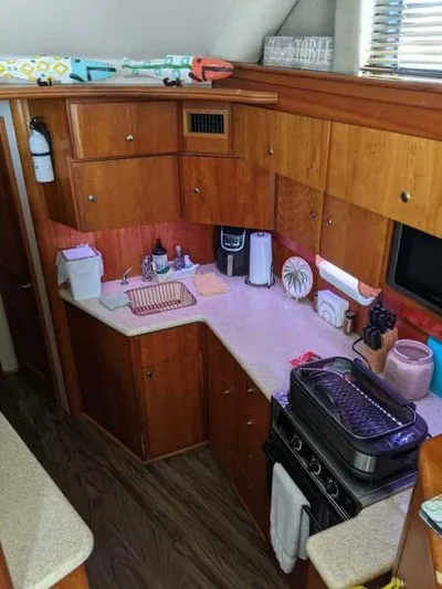 Yacht Photos Pics 2001 Silverton 42 Convertible yacht kitchen with wooden cabinets and modern appliances.