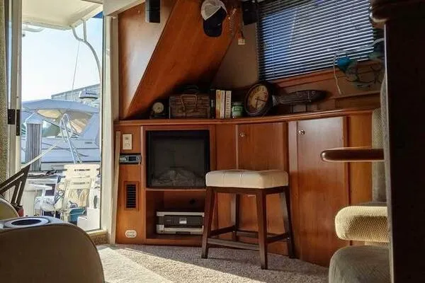  Yacht Photos Pics Interior of a 2001 Silverton 42 Convertible yacht with wooden cabinetry and seating.