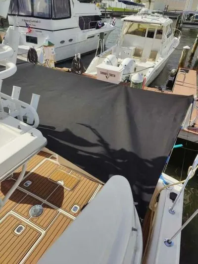  Yacht Photos Pics 2001 Silverton 42 Convertible yacht docked with sunshade and wooden deck.