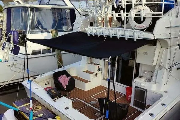  Yacht Photos Pics 2001 Silverton 42 Convertible yacht with shaded deck and fishing gear.