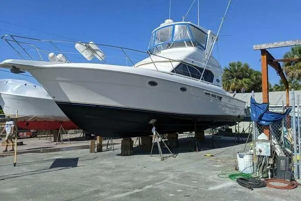 Yacht Photos Pics 2001 Silverton 42 Convertible yacht on dry dock under clear blue sky.