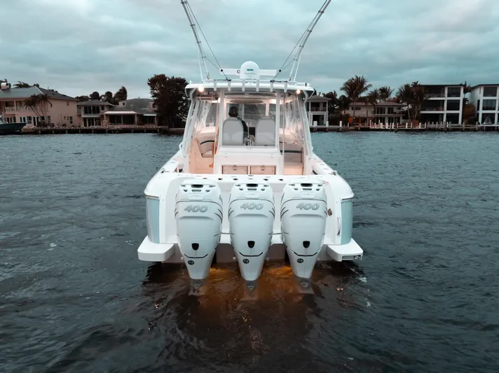  Yacht Photos Pics 2021 Intrepid 409 Valor boat with triple engines on a calm waterfront.