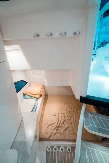  Yacht Photos Pics 2021 Intrepid 409 Valor cabin interior with cozy bed and modern design.