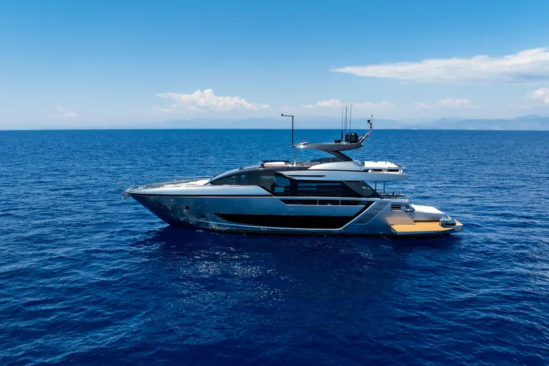 Coco Y Yacht Photos Pics Luxury 2025 Riva 82' Diva yacht cruising on open sea under clear blue sky.