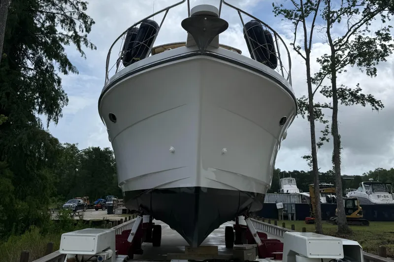 Adagio Yacht Photos Pics 2005 Jefferson Rivanna 50 SDMY yacht on dry dock, surrounded by trees and other boats.