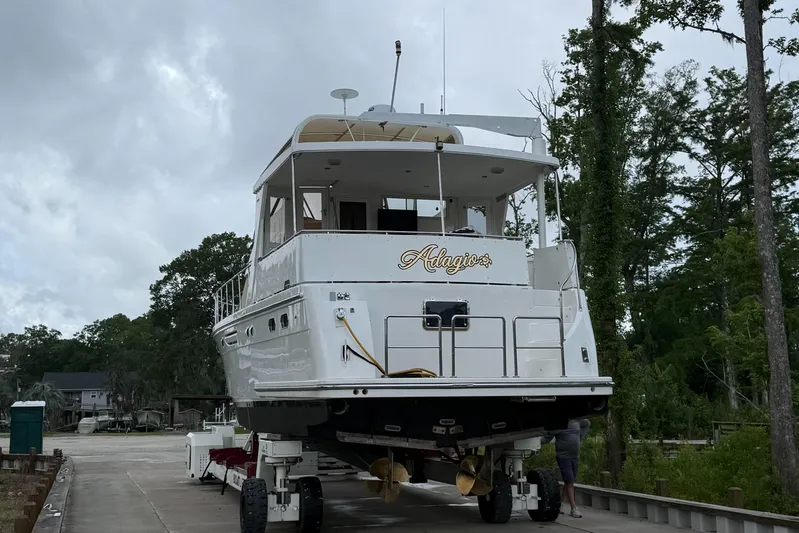 Adagio Yacht Photos Pics 2005 Jefferson Rivanna 50 SDMY yacht on trailer, surrounded by trees and cloudy sky.