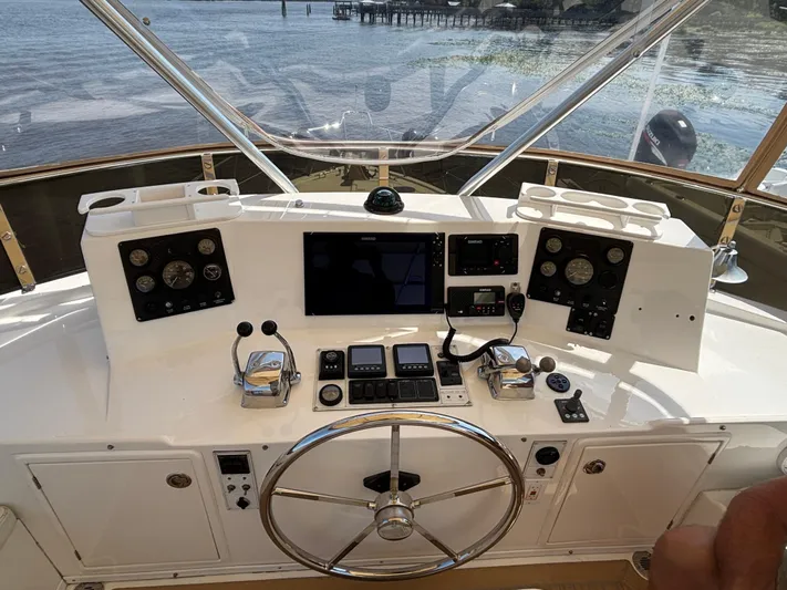 Adagio Yacht Photos Pics Helm of 2005 Jefferson Rivanna 50 SDMY yacht with navigation controls and steering wheel.