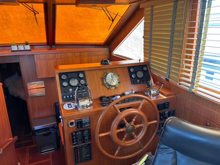 Adagio Yacht Photos Pics 2005 Jefferson Rivanna 50 SDMY yacht helm with wooden steering wheel and navigation instruments.