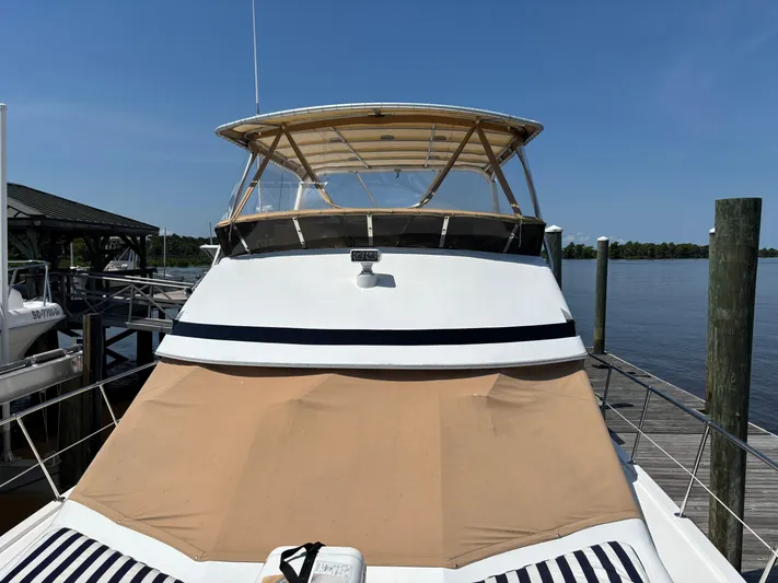 Adagio Yacht Photos Pics 2005 Jefferson Rivanna 50 SDMY yacht docked by a serene waterfront.