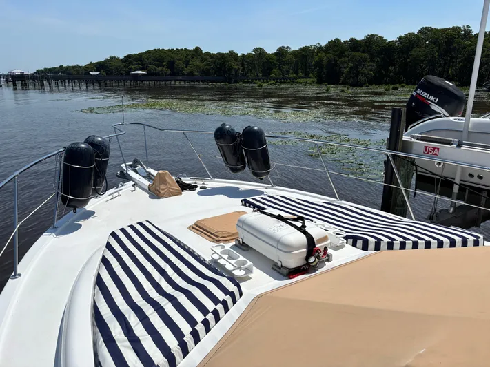 Adagio Yacht Photos Pics 2005 Jefferson Rivanna 50 SDMY yacht with striped sunbeds on a serene river.