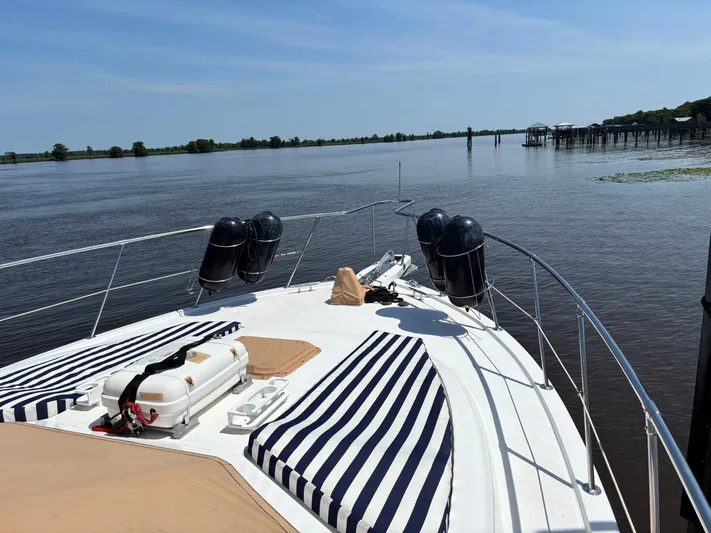 Adagio Yacht Photos Pics 2005 Jefferson Rivanna 50 SDMY yacht on calm river with striped cushions.
