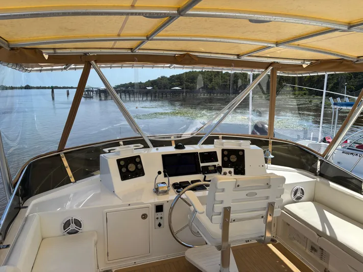 Adagio Yacht Photos Pics Helm of 2005 Jefferson Rivanna 50 SDMY yacht with scenic waterway view.