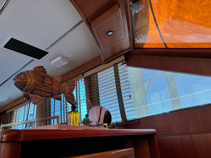 Adagio Yacht Photos Pics Interior of 2005 Jefferson Rivanna 50 SDMY yacht with wooden decor and fish sculpture.