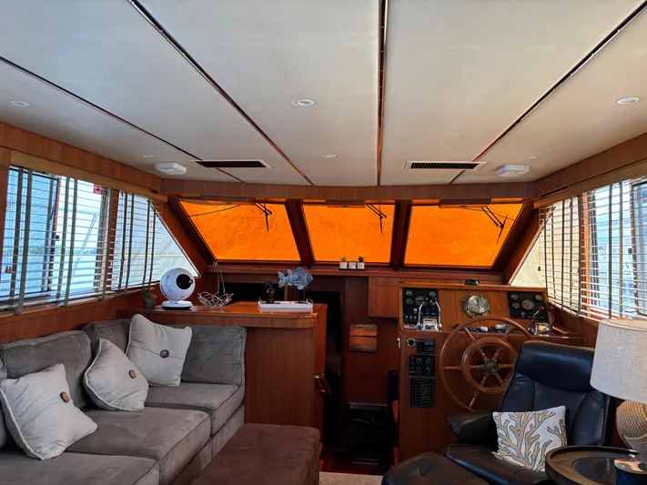 Adagio Yacht Photos Pics Luxurious interior of a 2005 Jefferson Rivanna 50 SDMY yacht with plush seating and helm.