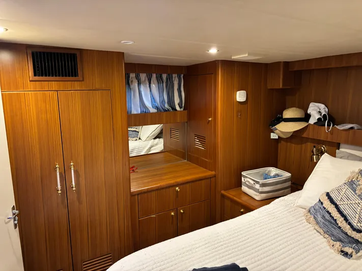 Adagio Yacht Photos Pics Luxurious cabin interior of 2005 Jefferson Rivanna 50 SDMY yacht with wood paneling and cozy bedding.