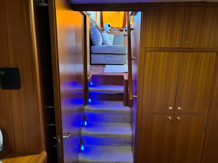 Adagio Yacht Photos Pics Interior of 2005 Jefferson Rivanna 50 SDMY yacht with carpeted stairs and wooden cabinetry.