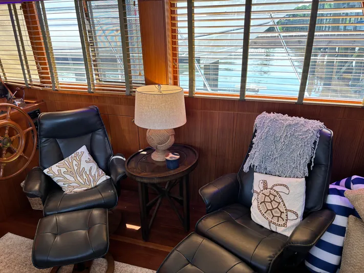 Adagio Yacht Photos Pics Luxurious 2005 Jefferson Rivanna 50 SDMY yacht interior with leather chairs and nautical decor.