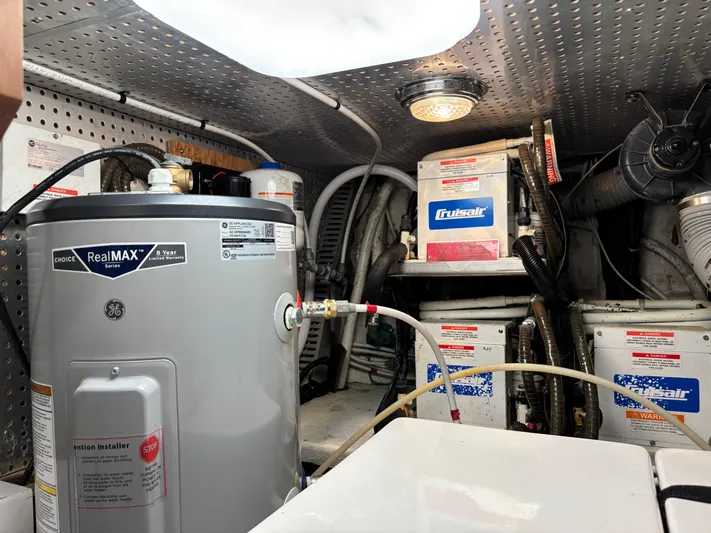 Adagio Yacht Photos Pics Engine room of 2005 Jefferson Rivanna 50 SDMY with water heater and air conditioning units.