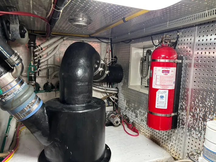 Adagio Yacht Photos Pics Engine room of 2005 Jefferson Rivanna 50 SDMY with fire extinguisher and exhaust system.