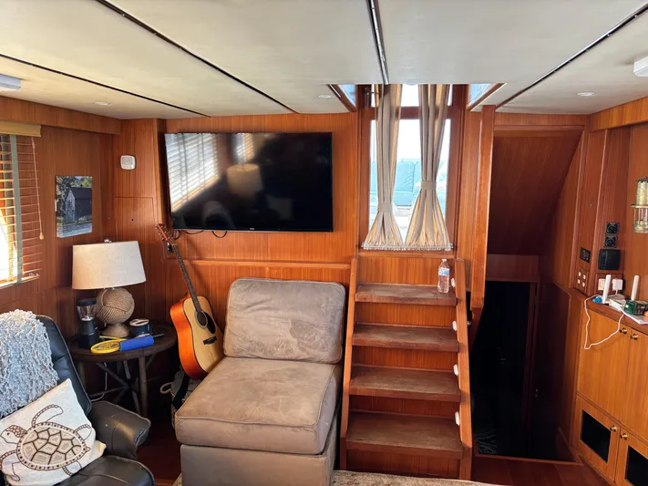 Adagio Yacht Photos Pics Interior of 2005 Jefferson Rivanna 50 SDMY yacht with cozy seating, guitar, and TV.