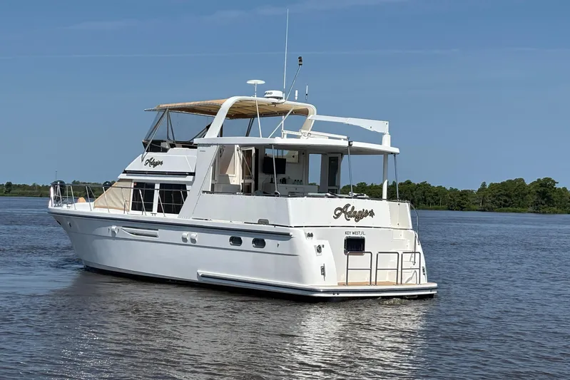 Adagio Yacht Photos Pics 2005 Jefferson Rivanna 50 SDMY yacht cruising on a calm river under clear skies.