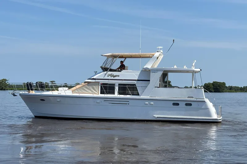 Adagio Yacht Photos Pics 2005 Jefferson Rivanna 50 SDMY yacht cruising on calm waters under a clear blue sky.