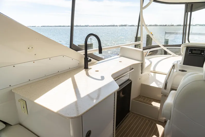  Yacht Photos Pics Luxurious 2008 Marquis 50 LS yacht interior with kitchenette and ocean view.