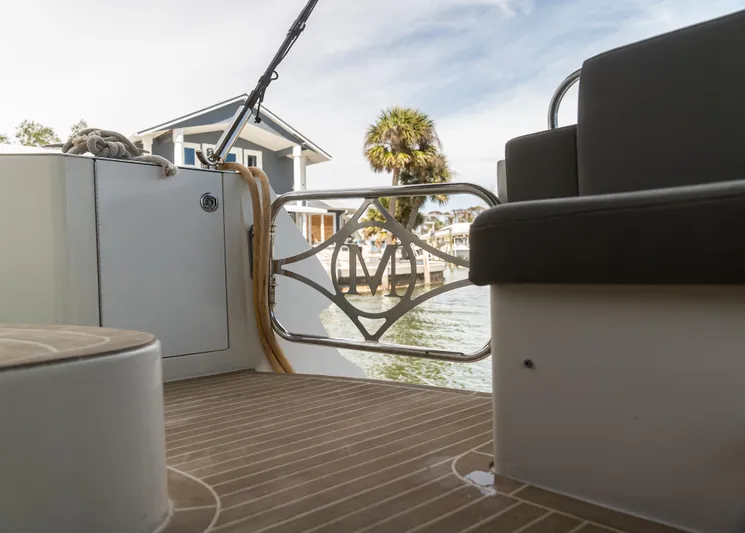  Yacht Photos Pics 2008 Marquis 50 LS yacht deck with elegant railing, overlooking waterfront and palm tree.