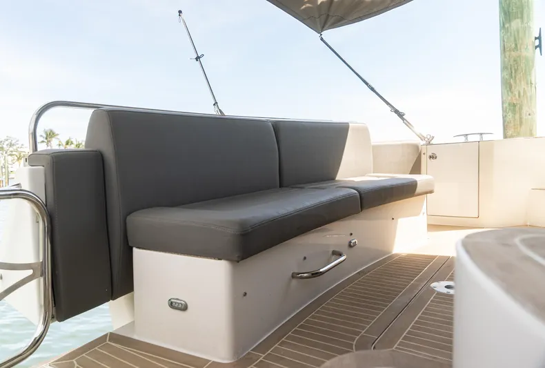  Yacht Photos Pics 2008 Marquis 50 LS yacht seating area with cushioned bench and teak flooring.