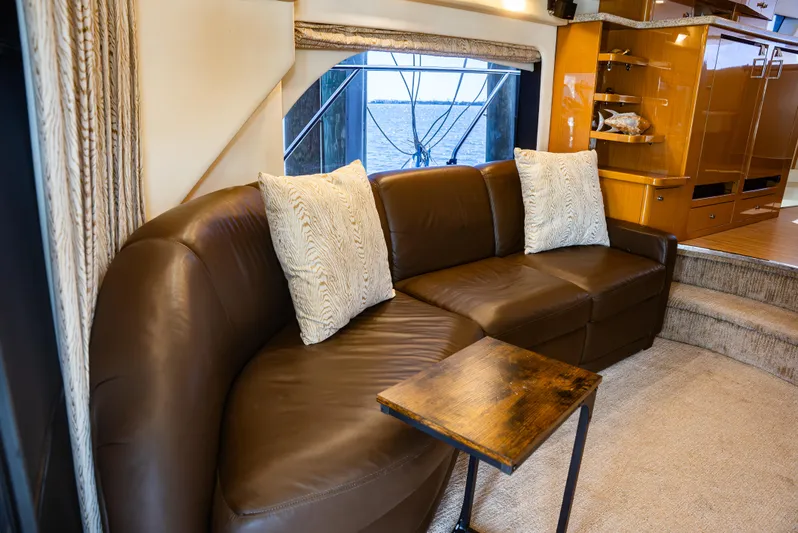  Yacht Photos Pics Luxurious interior of 2008 Marquis 50 LS yacht with brown leather sofa and scenic window view.