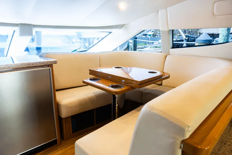  Yacht Photos Pics Interior of 2008 Marquis 50 LS yacht with elegant seating and wooden table.
