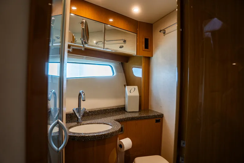  Yacht Photos Pics Luxurious bathroom in 2008 Marquis 50 LS yacht with modern fixtures and wood accents.
