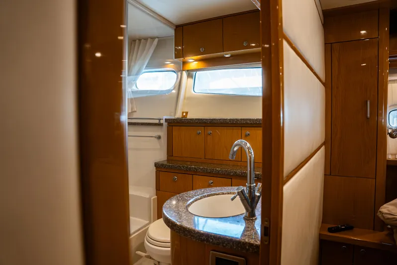  Yacht Photos Pics Luxurious bathroom interior of 2008 Marquis 50 LS yacht with modern fixtures and wood cabinetry.