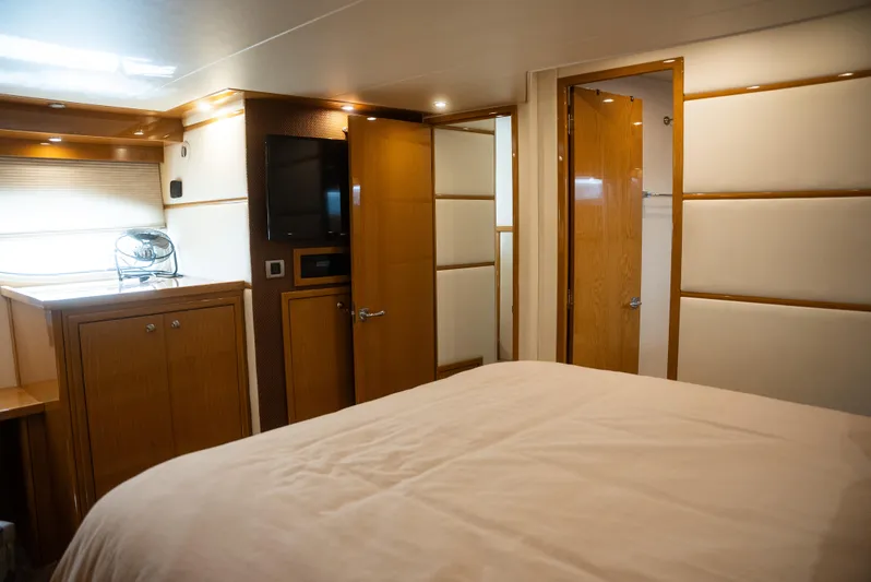  Yacht Photos Pics Luxurious bedroom interior of 2008 Marquis 50 LS yacht with wood paneling and modern amenities.