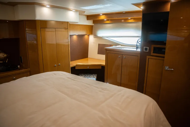  Yacht Photos Pics Luxurious interior of 2008 Marquis 50 LS yacht with wood finishes and cozy bedding.