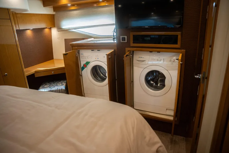  Yacht Photos Pics Laundry area inside 2008 Marquis 50 LS yacht with washer and dryer units.
