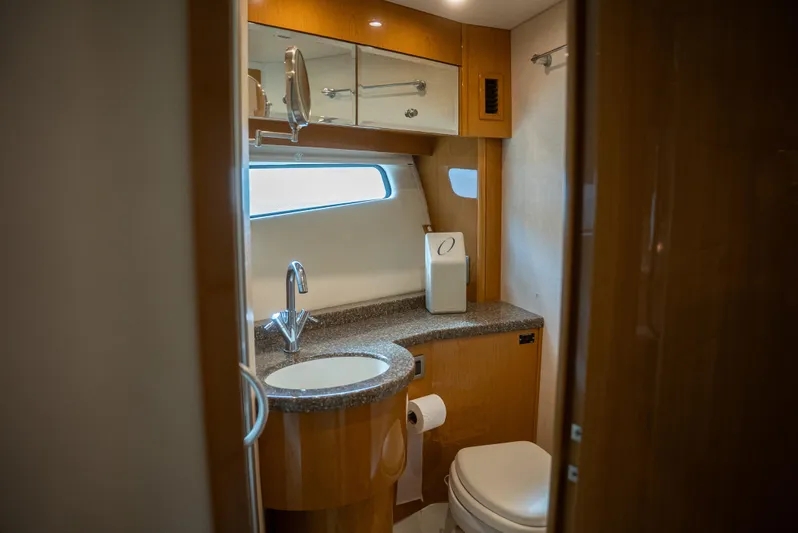  Yacht Photos Pics Luxurious bathroom in 2008 Marquis 50 LS yacht with modern fixtures and wood accents.