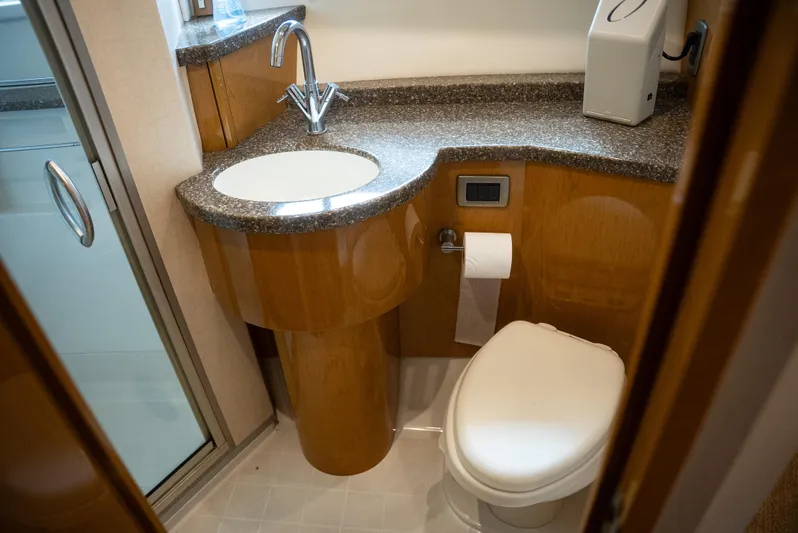  Yacht Photos Pics Luxurious bathroom in 2008 Marquis 50 LS yacht with modern fixtures and wood accents.