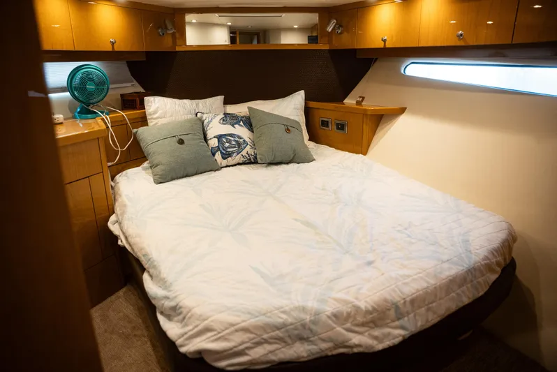  Yacht Photos Pics Luxurious 2008 Marquis 50 LS yacht bedroom with cozy bedding and elegant wood cabinetry.