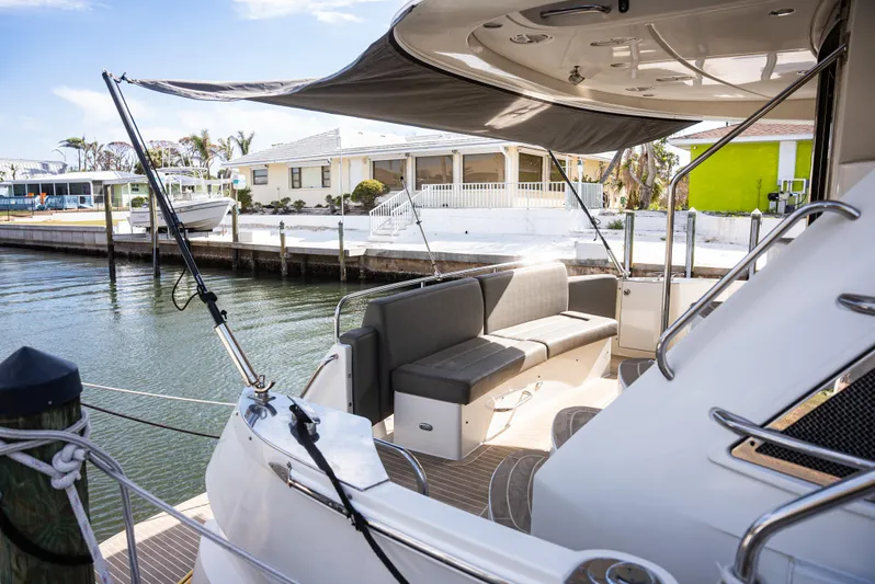  Yacht Photos Pics 2008 Marquis 50 LS yacht docked, featuring a shaded seating area and waterfront view.