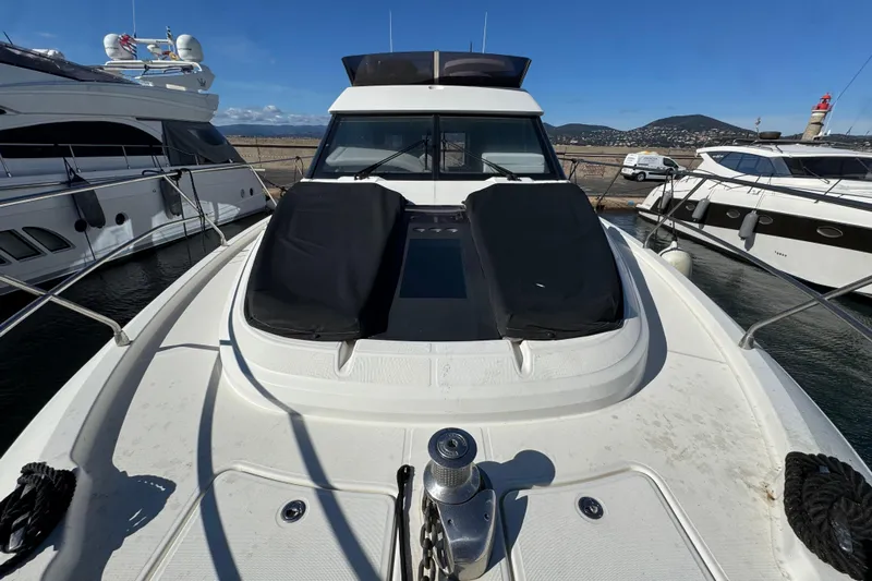  Yacht Photos Pics 2020 Monte Carlo 52 yacht docked at marina, featuring sleek design and spacious deck.