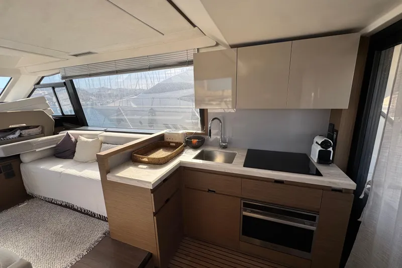  Yacht Photos Pics Luxurious 2020 Monte Carlo 52 yacht interior with modern kitchen and seating area.